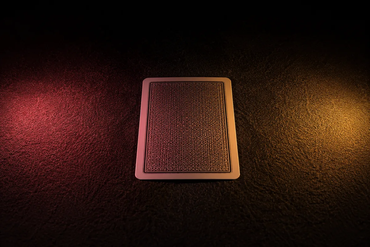 Abstract photo of a single playing card face-down on dark felt